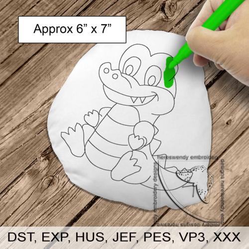 Image of design DD003 of a smiling crocodile cuddly  colouring in stuffie, with child's hand colouring it in with a size label sating it is approximately 6" x 7" and what machine formats it is available in