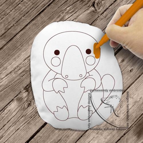 Cute platypus colouring stuffie ITH machine embroidery design with child's hand colouring it in